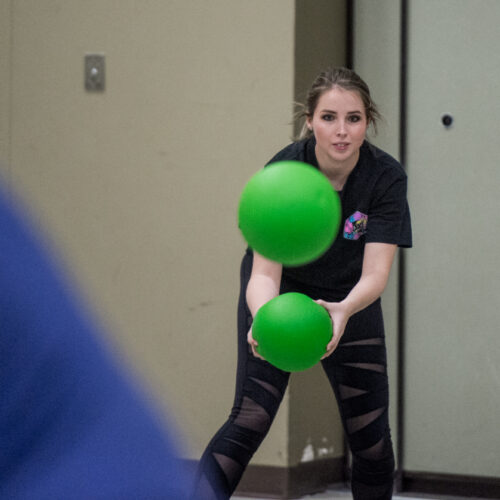 A woman blocking a ball in dodgeball.