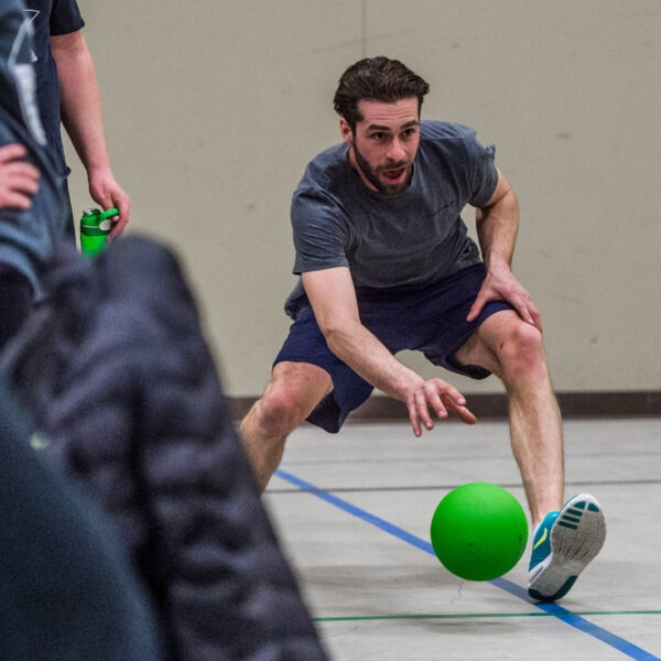 Dodgeball player reaching for a ball.