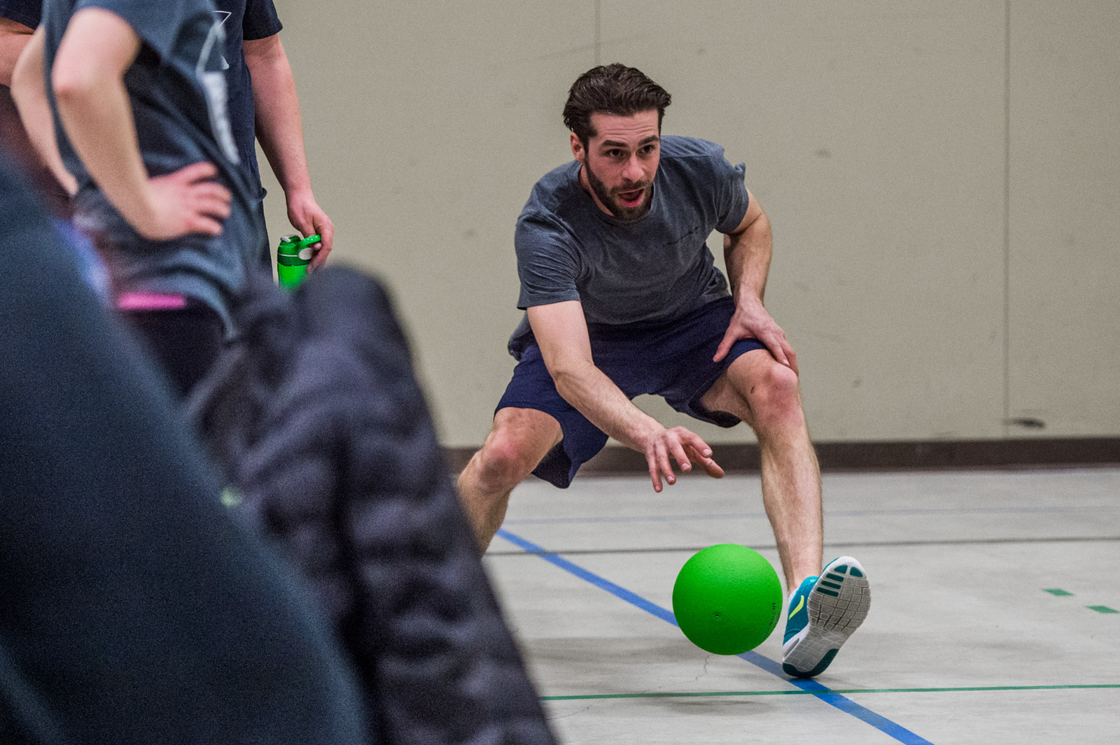 Dodgeball player reaching for a ball.